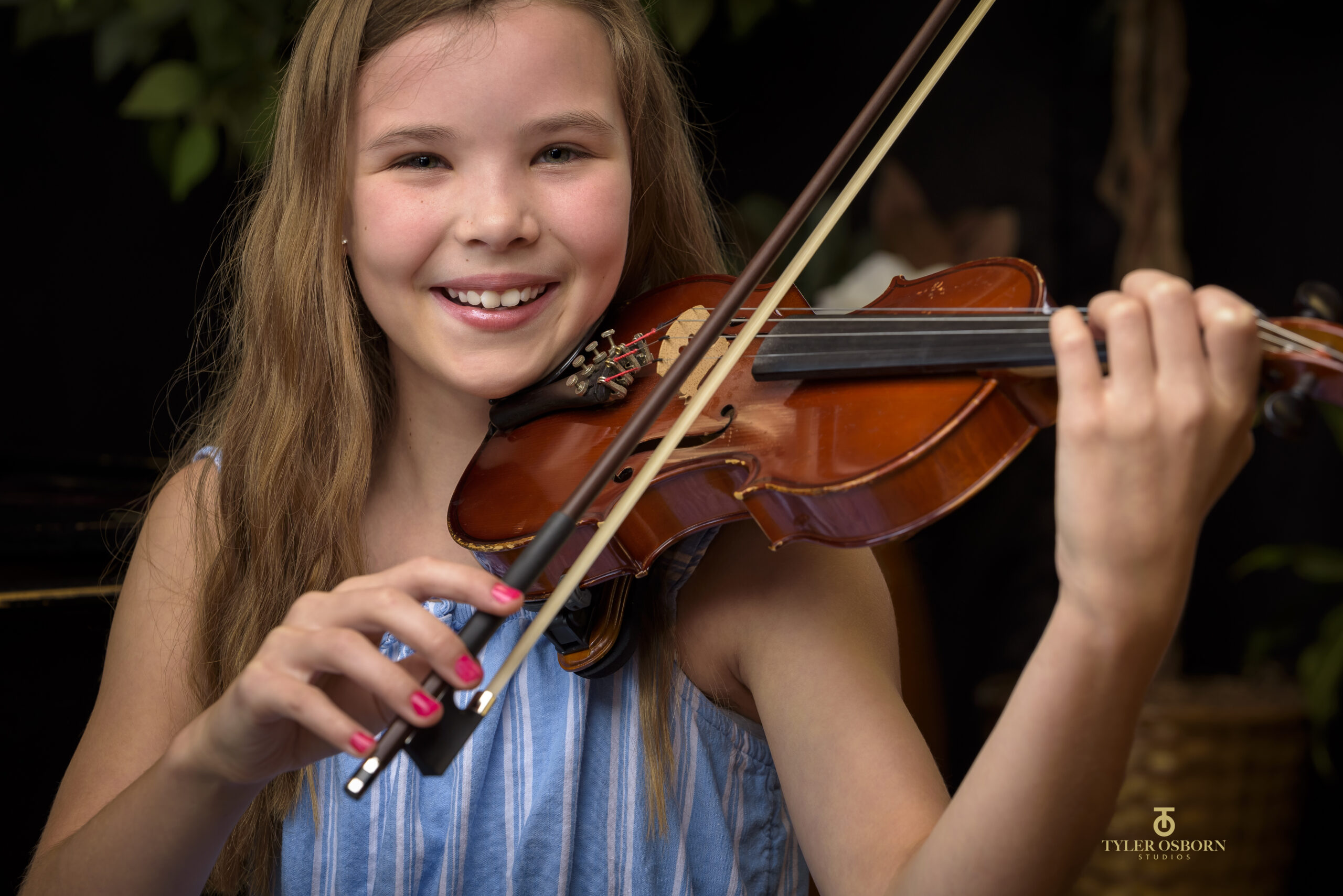 Child playing violin during music lesson